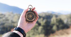 Person holding up a compass